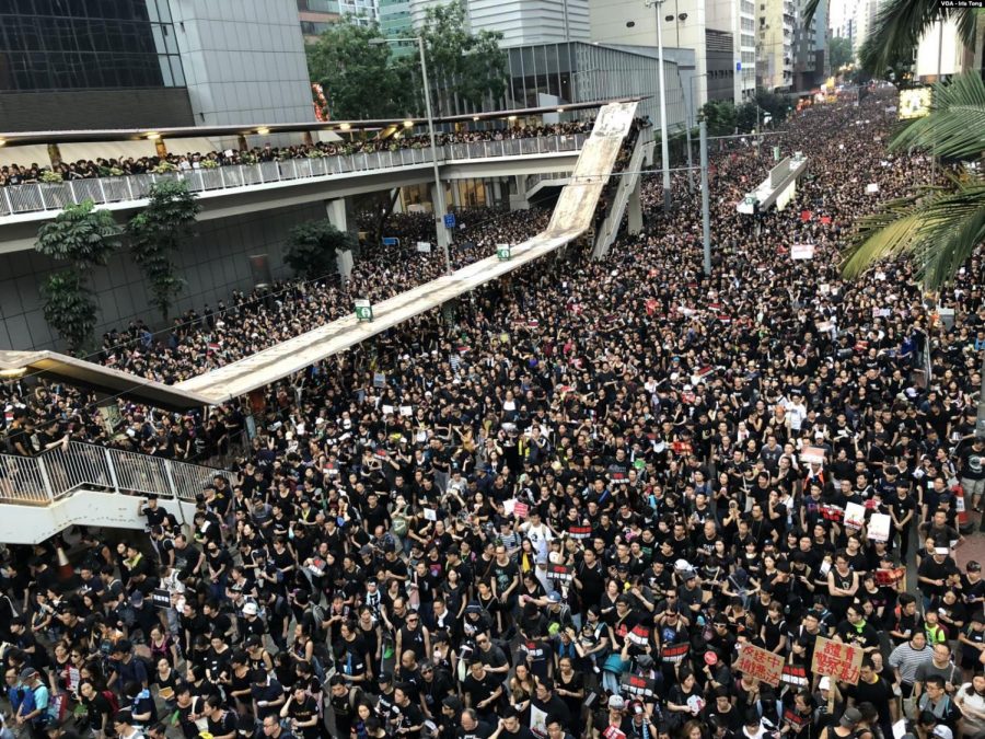 Protesters in black in Hong Kong, large amount of people forces police to open up more roads.
Taken from Wikimedia Commons