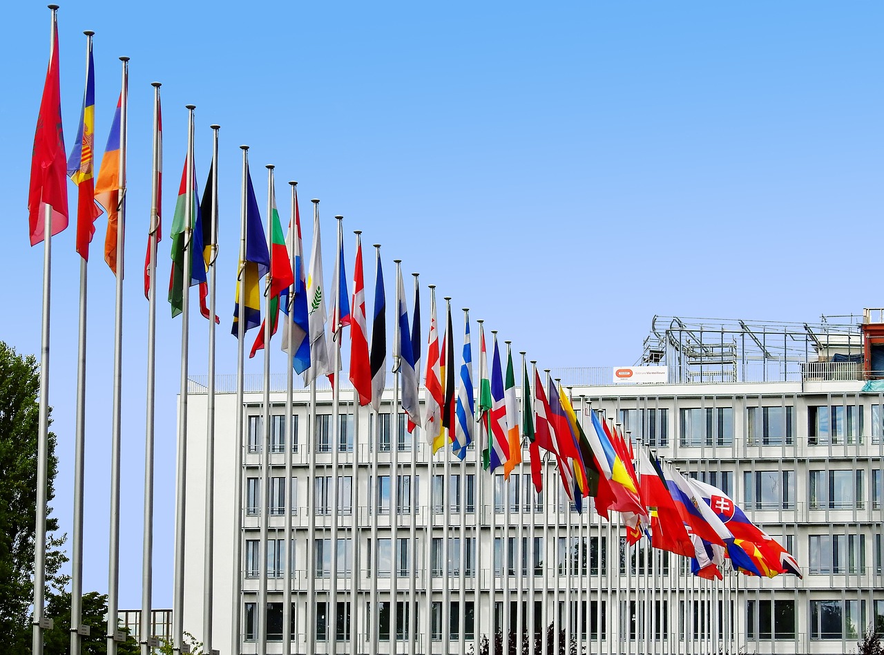 Slovakian, German, Spanish, English, and Dutch flags against blue